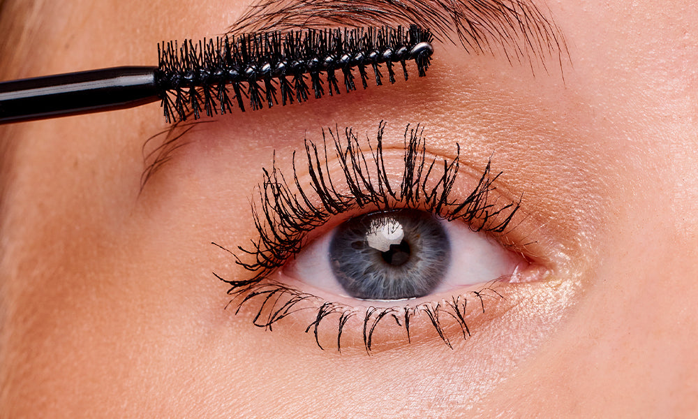 Using A Brush To Thicken Her Eyelashes